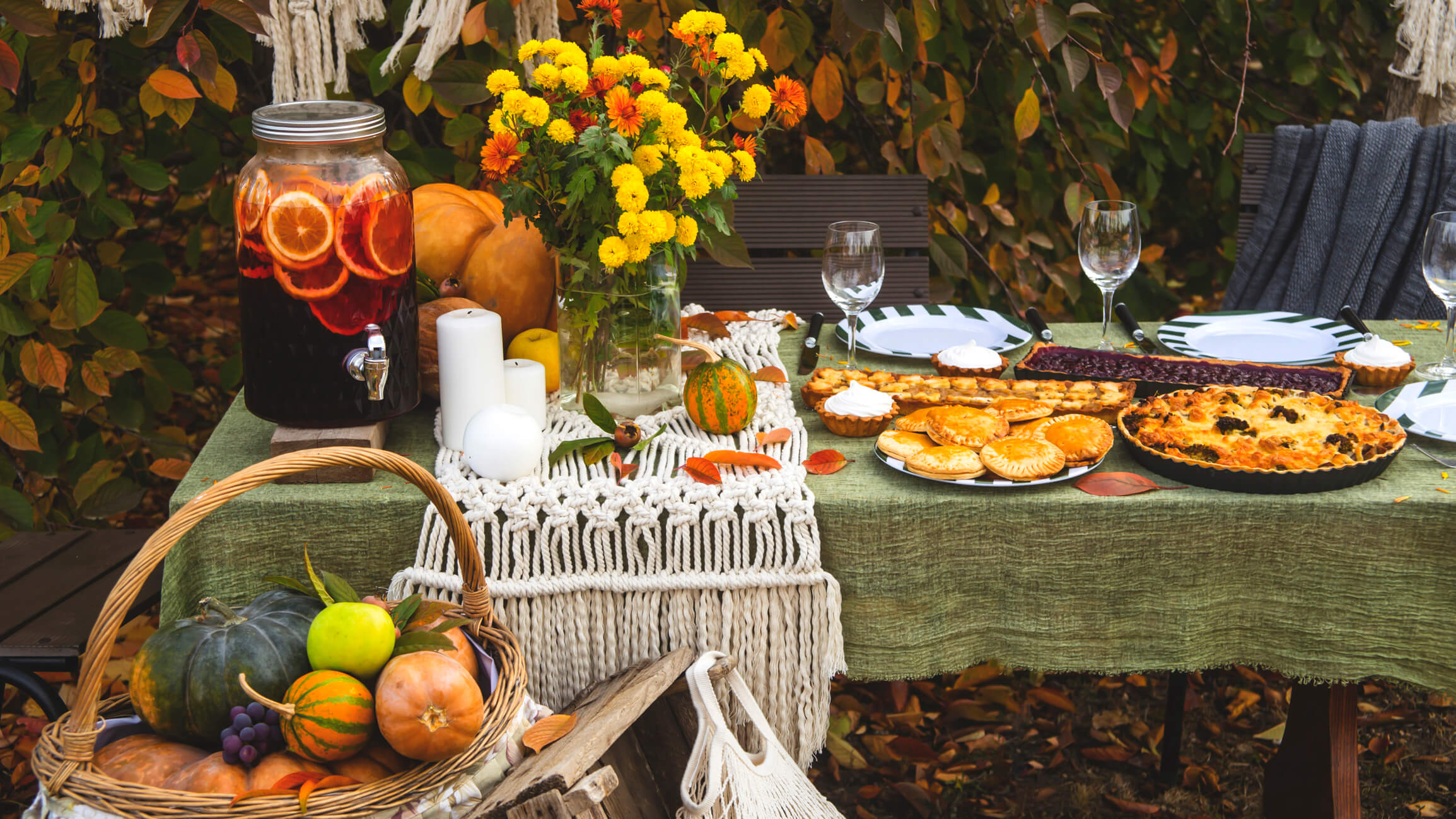 a backyard garden party with a table of flowers and food from the garden