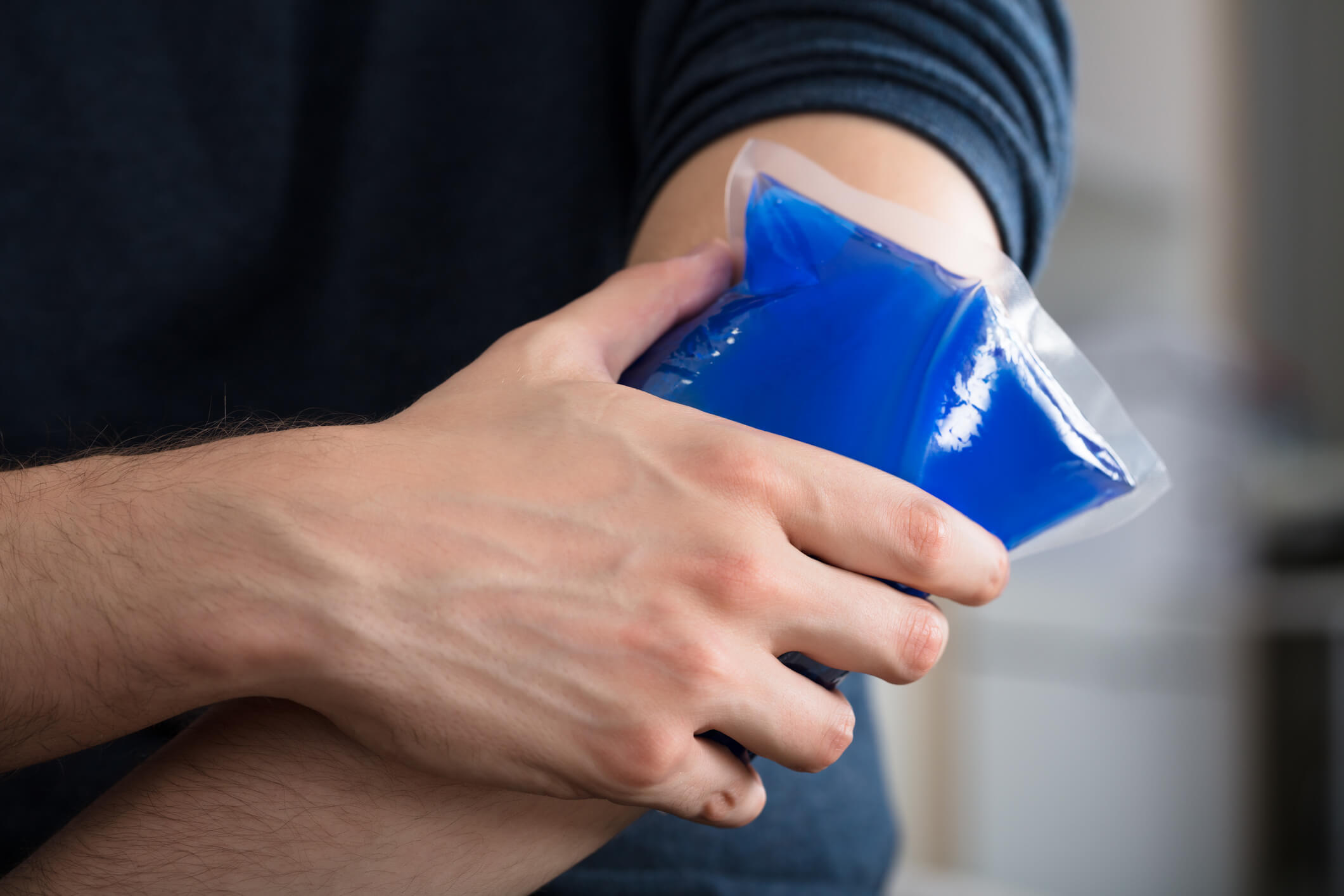 a person putting an ice pack on a pulse point to cool down in the heat