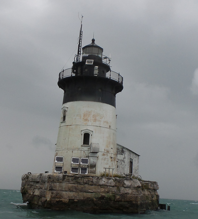 A weather antenna installed at the top of a lighthouse in Detroit River