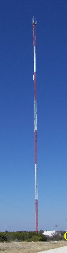 A tall weather tower with a cloudy sky